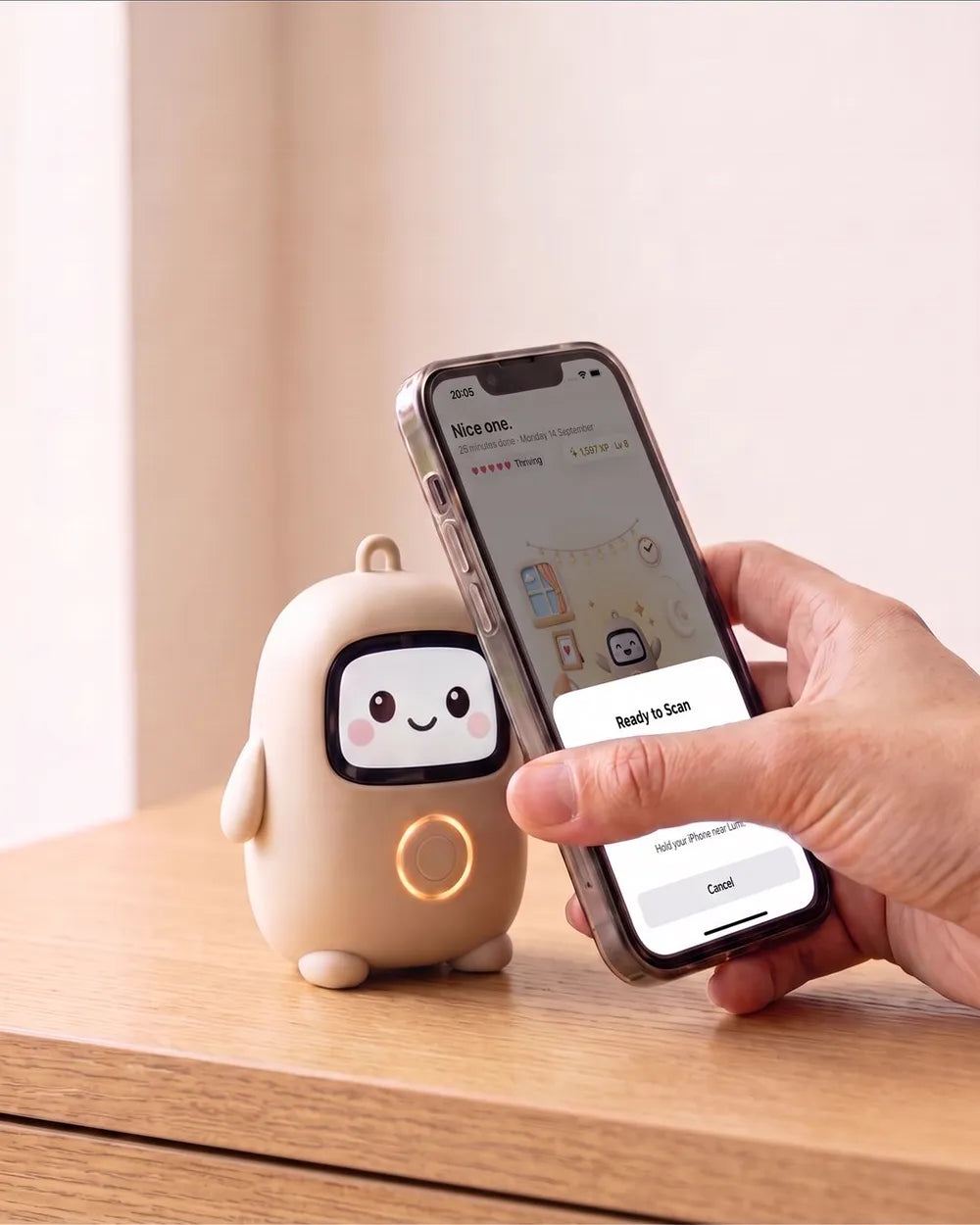 A hand holding a phone against Lumi to start a session